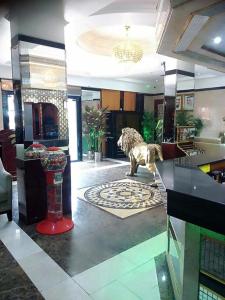 a lobby with a statue of a lion on the floor at West Hotel in Dubai