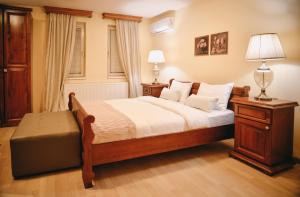 a bedroom with a bed and two lamps in it at Casa Botisa - Luxury Villa with private pool in Kumanovo