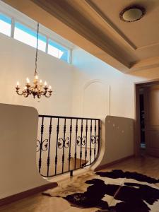 a chandelier in a room with a staircase at Casa Botisa - Luxury Villa with private pool in Kumanovo