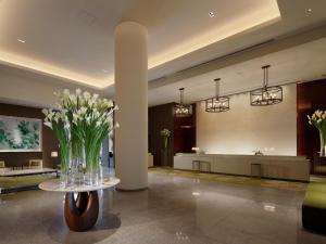 a lobby with a vase of flowers on a table at Palace Hotel Tokyo in Tokyo