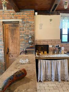 a kitchen with a table and a stove at გურული ეზო*Gurian yard in Chala