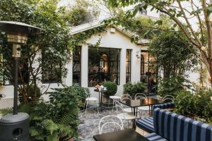 a patio with tables and chairs in front of a building at Hôtel Bienvenue in Paris