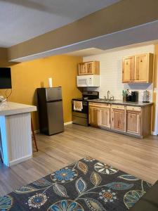 a kitchen with a black refrigerator and wooden cabinets at River getaway Downstairs unit in Bullhead City