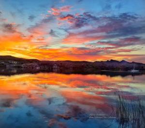 a reflection of a sunset in a body of water at Beach Happy-Lake Close-Private Waterpark Oasis -sleeps 14 in Lake Havasu City
