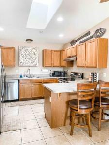 a kitchen with wooden cabinets and a counter top at Beach Happy-Lake Close-Private Waterpark Oasis -sleeps 14 in Lake Havasu City