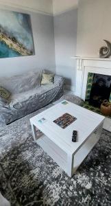 a living room with a coffee table and a couch at Dune Cottage in Caister-on-Sea
