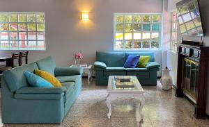 a living room with two couches and a coffee table at Hotel Evoque Sáchica in Villa de Leyva