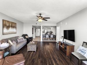 a living room with a couch and a flat screen tv at North Tower #802 Condo in Myrtle Beach
