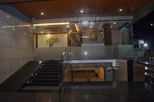 a lobby with a staircase in a building at HOTEL CENTRUM in Kota