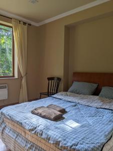 a bedroom with two beds and a window at Forest in Dilijan