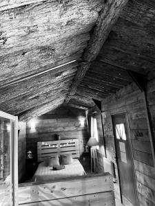 a bedroom with a bed in a wooden cabin at Chambre avec spa privé in Candor