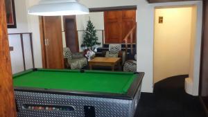 a living room with a pool table in it at Victoria Hotel in Bredasdorp