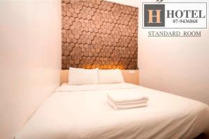 Postel nebo postele na pokoji v ubytování H Hotel