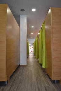 a hallway with wooden doors and green walls at Santiago de Vilavella in Redondela