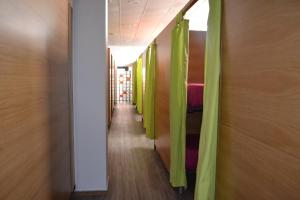 a corridor with green curtains in a hallway at Santiago de Vilavella in Redondela