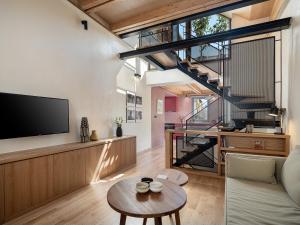 a living room with a tv and a table at Austrinus house, luxury property for max. 5 persons in Chania Town