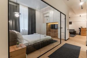 a bedroom with a bed and a glass wall at Silver Luxury Suites in Belgrade