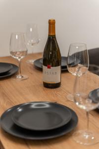 a bottle of wine sitting on a table with glasses at Silver Luxury Suites in Belgrade