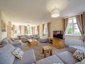 a living room with couches and a flat screen tv at Renchers Farmhouse in Crossway Green