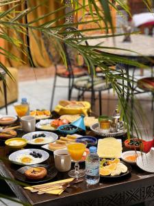 a table filled with plates of food and drinks at Riad Majorelle in Rabat +67 photos