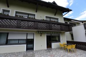 a balcony on a house with yellow chairs at LakeView Apartment in Preddvor