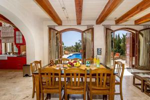 a dining room with a table with a bowl of fruit on it at The Almonds Luxury Villa in San Lawrenz