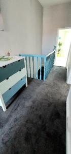 a room with a blue dresser and a blue crib at Dune Cottage in Caister-on-Sea