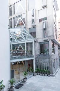 a building with a glass facade with potted plants at 9ine Thamel Hotel in Kathmandu