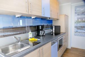 a kitchen with a sink and a counter top at Beach Lodge BL03 in Cuxhaven