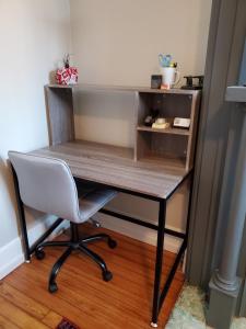 a desk with a chair in a room at Walkable And Cozy German Village Hauspets Ok in Columbus