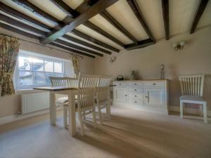 a dining room with a table and chairs at Kings Head Cottage in Pickering