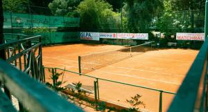 a tennis court with a net on top of it at I giardini di Santomaj in Leporano