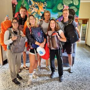 a group of people posing for a picture with their backpacks at Central Hostel in Antigua Guatemala