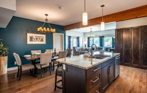 a kitchen and dining room with a table and chairs at Downunder Mountain Retreat by Revelstoke Vacations in Revelstoke