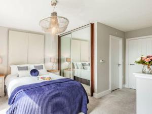 a bedroom with a large bed and a large mirror at Violet Place in Broomfield