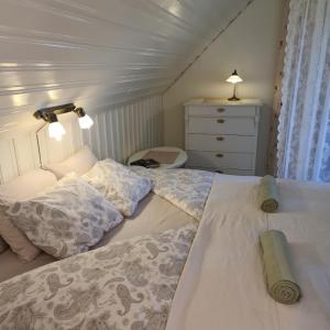 a bedroom with two beds and a dresser at Vanneberga gamla skola in Fjälkinge