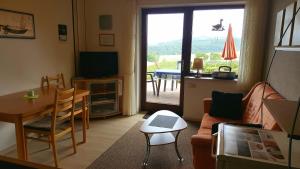 a living room with a couch and a table at Ferienwohnung Haus Weitblick in Medebach