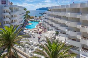 an aerial view of a resort with a pool and palm trees at FERGUS Style Cala Blanca Suites in Santa Ponsa