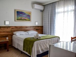 a hotel room with a bed and a window at Hotel Appel in Santa Maria