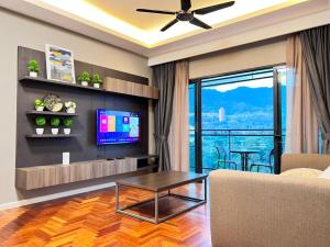 a living room with a couch and a tv at Genting Highlands Vista Residences Free Wi-Fi & 1 Parking in Genting Highlands