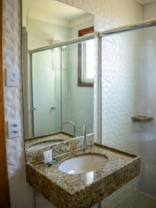 a bathroom with a sink and a mirror at Hotel Appel in Santa Maria