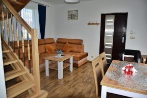 a living room with a couch and a table at Domek u Zbyszka in Groń