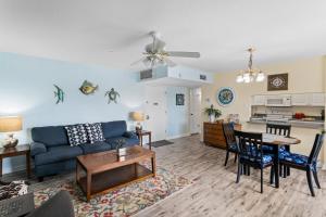 a living room with a blue couch and a table at #231 E Madeira Beach Yacht Club in St Pete Beach