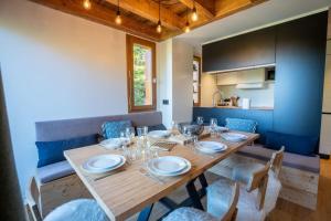 a dining room with a wooden table and chairs at Hauts de Chantemouche 17 in Méribel