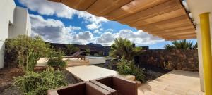 a patio with a view of the mountains from a house at Sand Volcano Villa 2 in La Oliva