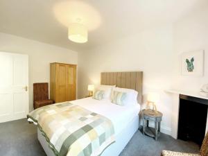 a bedroom with a bed with a checkered blanket at Tramontane Apartment at Hesketh Crescent in Torquay