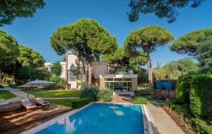 a house with a swimming pool and trees at Club Prive By Rixos Belek in Belek