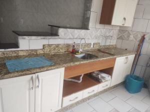 a kitchen with a sink and a counter top at Apartamento amplo pé na areia - Itapema 180m da Praia in Itapema +29 photos