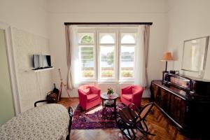 sala de estar con sillas rojas y ventana en BudaFlats Apartments, en Budapest