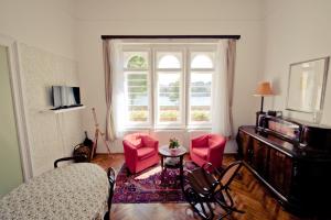 a living room with red chairs and a window at BudaFlats Apartments in Budapest